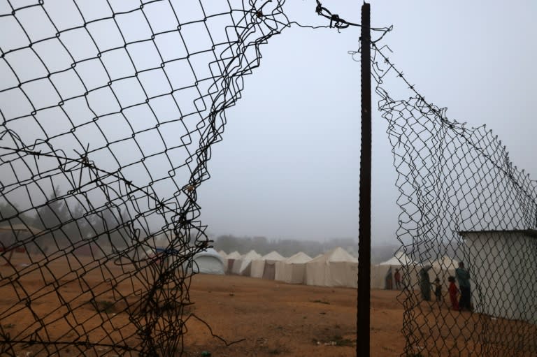 Palestinians queue to use lavatories at a tent camp for displaced people amid thick fog in Rafah in the southern Gaza Strip early morning on April 4, 2024, amid the ongoing conflict between Israel and the militant group Hamas. (MOHAMMED ABED)