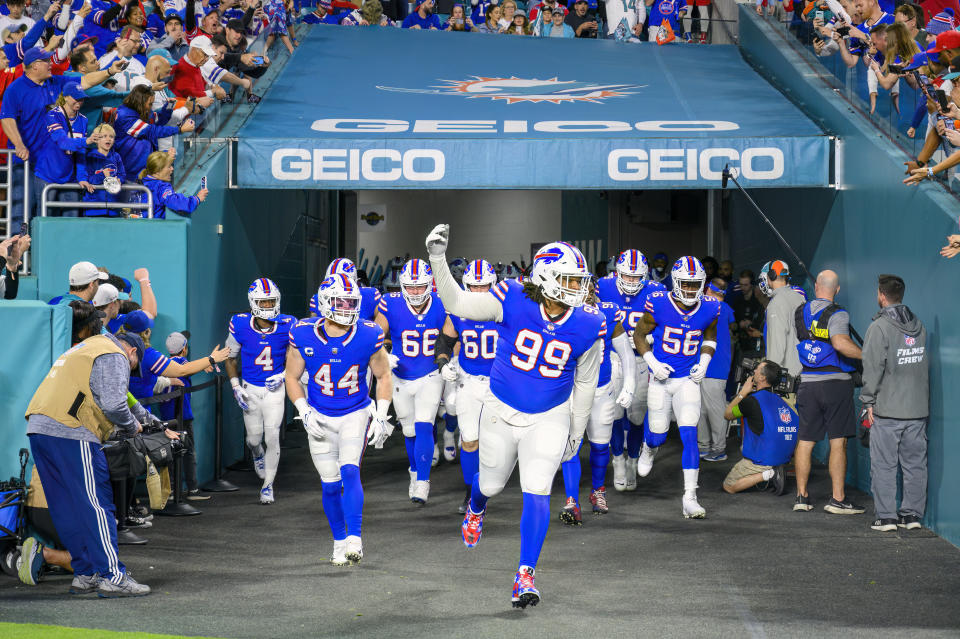 FILE - Buffalo Bills defensive tackle Tim Settle (99), linebacker Tyler Matakevich (44), guard Connor McGovern (66), center Mitch Morse (60), defensive end Leonard Floyd (56) and running back James Cook (4) lead the team onto the field before an NFL football game against the Miami Dolphins, Sunday, Jan. 7, 2024, in Miami Gardens, Fla. Police in South Florida say a man fatally shot a 30-year-old Buffalo Bills fan during an altercation outside Hard Rock Stadium after the Bills defeated the Miami Dolphins in the final regular season game, Sunday. (AP Photo/Doug Murray, File)