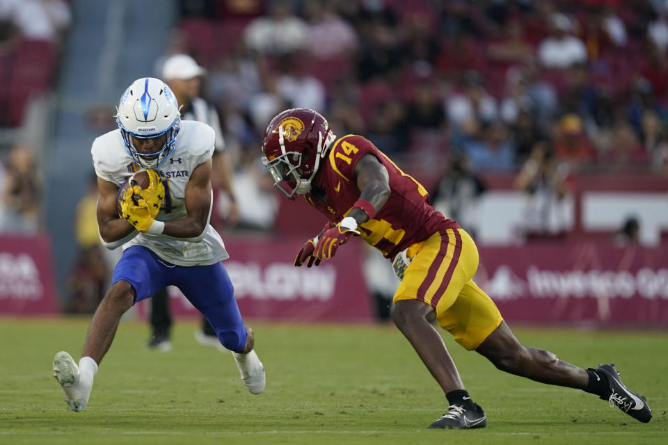 Southern California cornerback Jacobe Covington (14) prepares to tackle San Jose State wide receiver Charles Ross during the second half of an NCAA college football game Saturday, Aug. 26, 2023, in Los Angeles. (AP Photo/Ryan Sun)