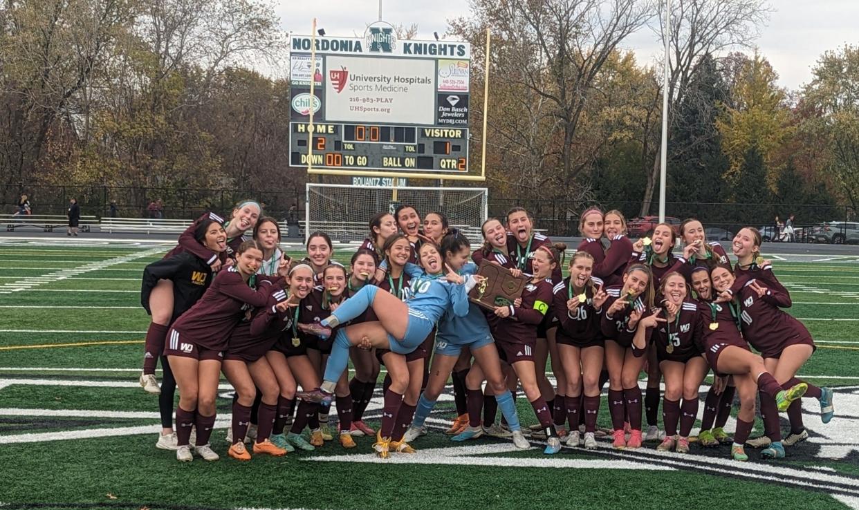 The Walsh Jesuit girls soccer team celebrates after beating Magnificat 2-1 in a Division I regional final.