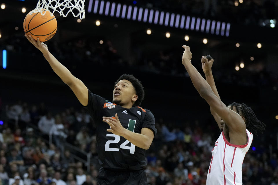 Miami guard Nijel Pack shoots past Houston guard Tramon Mark in the first half of a Sweet 16 college basketball game in the Midwest Regional of the NCAA Tournament Friday, March 24, 2023, in Kansas City, Mo. (AP Photo/Jeff Roberson)