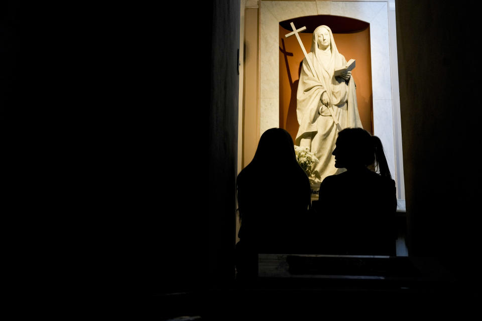 Florencia Pittaluga, right, and Maria Eugencia Iturriza, visit the tomb of María Antonia de Paz y Figueroa, more commonly known by her Quechua name of “Mama Antula,” at the Nuestra Senora de la Piedad Basilica, in Buenos Aires, Argentina, Tuesday, Jan. 30, 2024. The canonization of “Mama Antula” in a Feb. 11th ceremony to be presided by Pope Francis at St. Peter's Basilica marks the first time a female from Argentina will become saint. (AP Photo/Natacha Pisarenko)