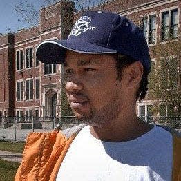 LaRon Bourgeois, stepfather of Alexis Patterson, stands in the intersection near her Milwaukee school, where Alexis was last seen, in 2002.