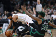 Miami Heat's Gabe Vincent (2) and Boston Celtics' Marcus Smart (36) compete for the ball during the first half of an NBA basketball game Friday, Dec. 2, 2022, in Boston. (AP Photo/Michael Dwyer)