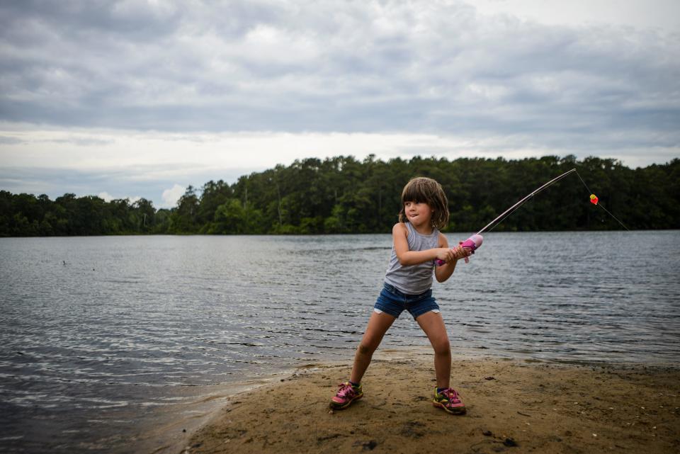 Nicole Starkey, 5, casts into Lake Rim while fishing with her grandmother Elizabeth Owens on Thursday, July 3, 2014.