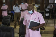 FILE - In this Friday, Feb. 26, 2021 file photo, Paul Rusesabagina, who inspired the film "Hotel Rwanda" and is credited with saving more than 1,000 people by sheltering them at the hotel he managed during the genocide, attends a court hearing in Kigali, Rwanda. A court in Rwanda said Monday, Sept. 20, 2021 that Rusesabagina, who boycotted the announcement after declaring he didn't expect justice in a trial he called a "sham", is guilty of terror-related offenses. (AP Photo/Muhizi Olivier, File)