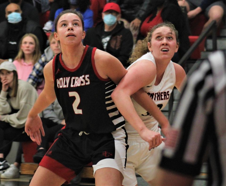 Holy Cross junior Julia Hunt, left, was tournament MVP Sunday.