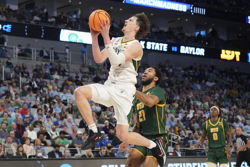 FILE - Baylor guard Matthew Mayer, left, drives past Norfolk State forward Dana Tate (21) during the second half of a college basketball game in the first round of the NCAA tournament in Fort Worth, Texas, Thursday, March 17, 2022. The Illini were big winners in the offseason transfer market though, securing the talents of former Texas Tech wing Terrence Shannon Jr. and Baylor forward Matthew Mayer. (AP Photo/LM Otero, File)