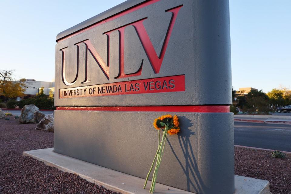 Flowers rest against a UNLV campus sign after a December 6 shooting left three dead (Getty Images)