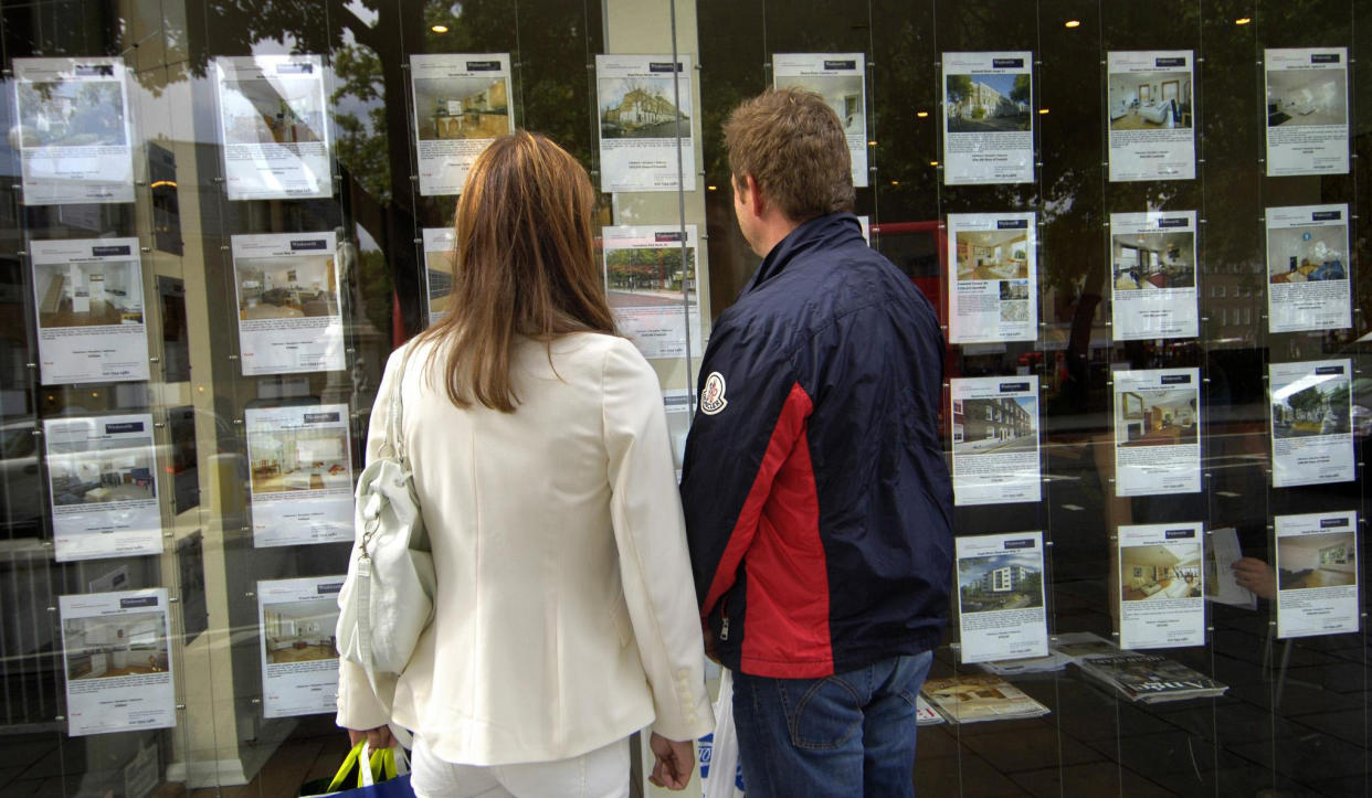 File photo dated 02/09/08 of people standing outside an estate agent's window. The average UK house price jumped by around ??8,000 annually in June, according to Office for National Statistics (ONS) figures.