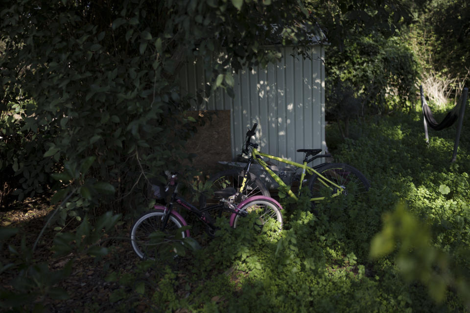 Bicycles of Raymond Reijnen's children are seen in the garden of his house in Kibbutz Nahal Oz, Israel, Wednesday, Feb. 7, 2024. (AP Photo/Leo Correa)