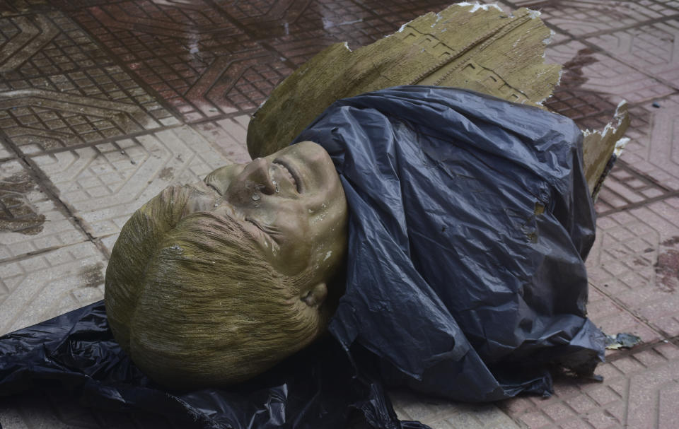 In this Jan. 13, 2020 photo, the destroyed bust of Bolivia's former President Evo Morales, lies on the ground after it was knocked down on the orders of Bolivia's sports minister, outside a sports center in Cochabamba, Bolivia. The sports center, which used to be named after the former president but the new government has changed its name to Quillacollo after its location. (Daniel James/Los Tiempos via AP)