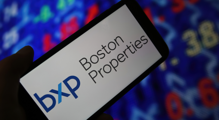 Closeup of mobile phone screen with logo lettering of boston properties, stock market chart background. BXP stock.