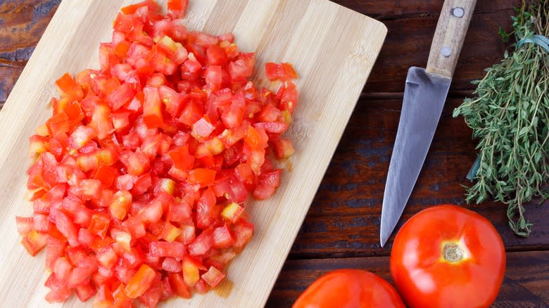 Diced tomatoes on wooden board