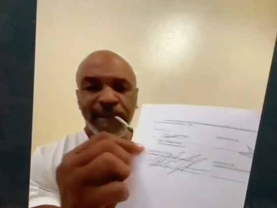 Mike Tyson shows off his contract to face Roy Jones Jr (royjonesjrofficial)