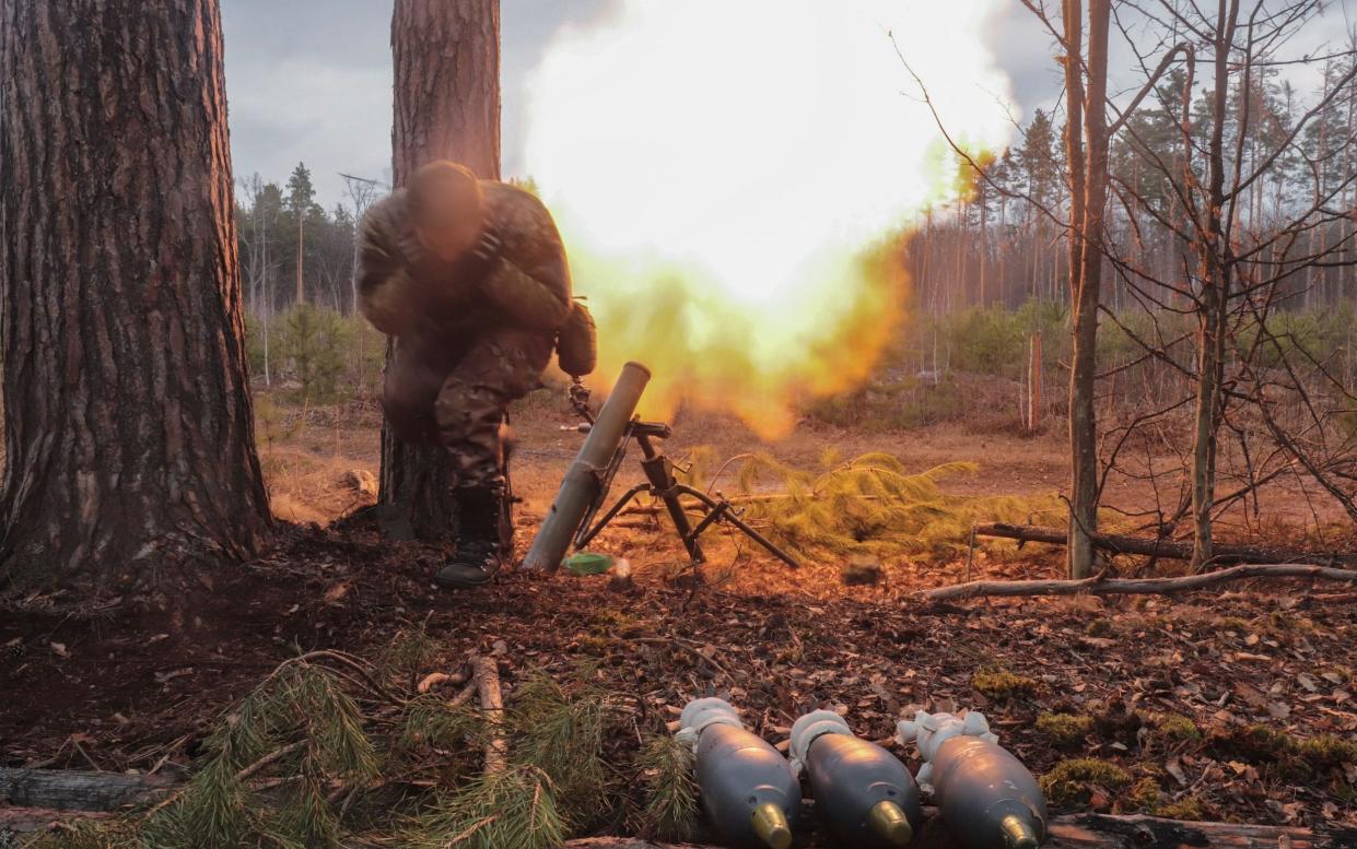 A Ukrainian serviceman fires a mortar towards Russian positions near Kyiv - Shutterstock