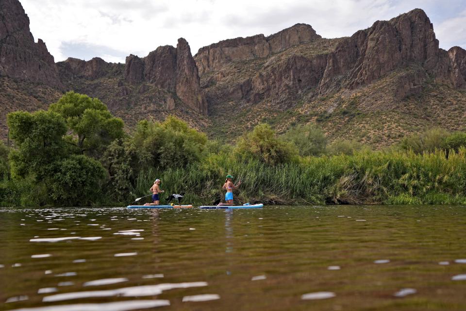 FILE - Paddle boarders float down the Salt River, July 12, 2023, in Mesa Ariz. (AP Photo/Matt York, File)