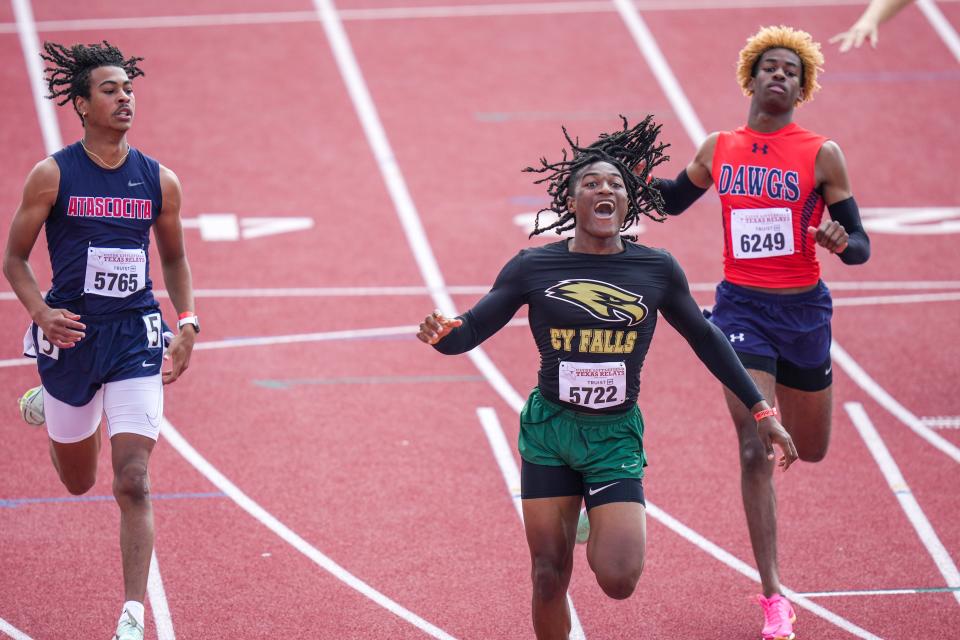 Houston Cypress' Jairius Burton celebrates as he crosses the finish line in the 100-meter hurdles on Friday. The Texas Relays conclude Saturday with a full day of high school, college and invitational events.