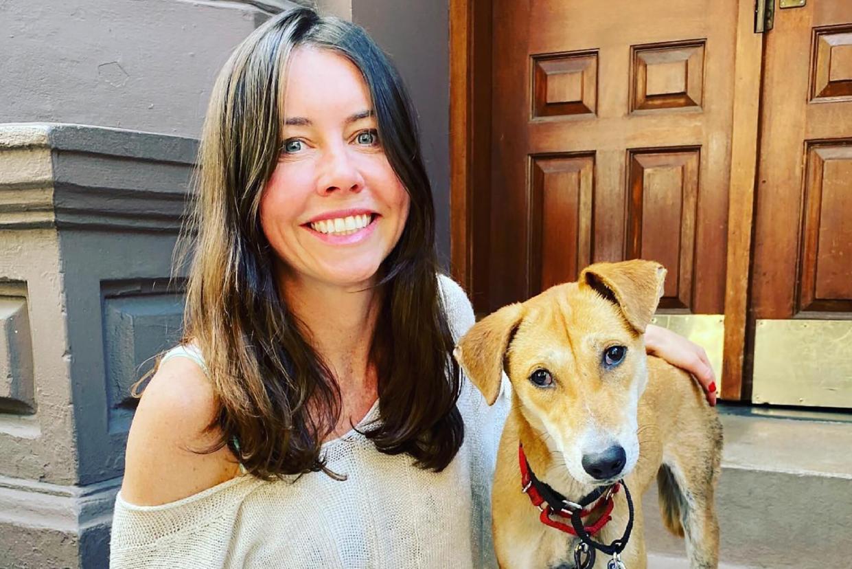 woman with her dog sitting on her front stoop