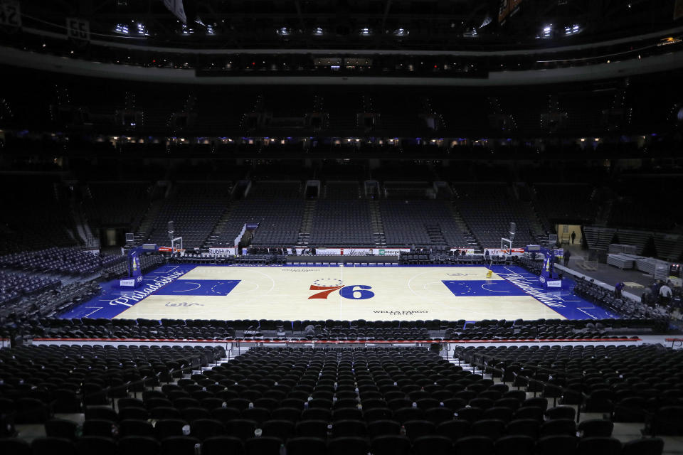 FILE - The empty court at the Wells Fargo Center is shown March 11, 2020, after an NBA basketball game between the Philadelphia 76ers and the Detroit Pistons, in Philadelphia. The Philadelphia 76ers, who currently play at Wells Fargo Center, are taking the first steps toward building a privately-funded sports and entertainment arena. The team's managing partners on Thursday, July 21, 2022 announced the creation of a new development company to create its future home in the city's Fashion District. (AP Photo/Matt Slocum, File)