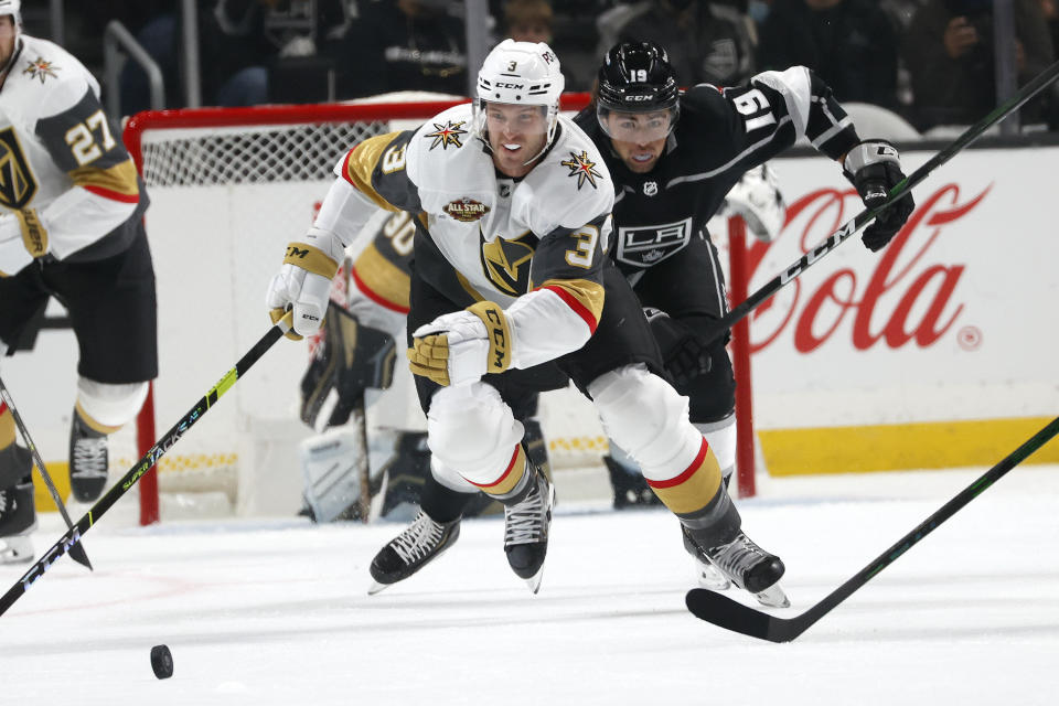 Vegas Golden Knights defenseman Brayden McNabb (3) controls the puck away from Los Angeles Kings forward Alex Iafallo (19) during the first period of an NHL hockey game Thursday, Oct. 14, 2021, in Los Angeles. (AP Photo/Ringo H.W. Chiu)