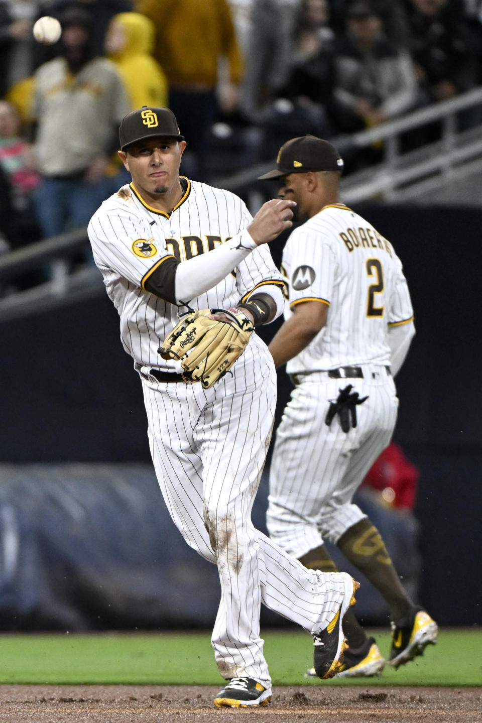 San Diego Padres third baseman Manny Machado throws to first for the out on Colorado Rockies' Ezequiel Tovar during the seventh inning of a baseball game in San Diego, Thursday, March 30, 2023. (AP Photo/Alex Gallardo)