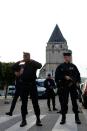 Police officers stand guard the Saint-Etienne church on July 27, 2016 in Saint-Etienne-du-Rouvray after a parish priest had his throat slit in a terror attack