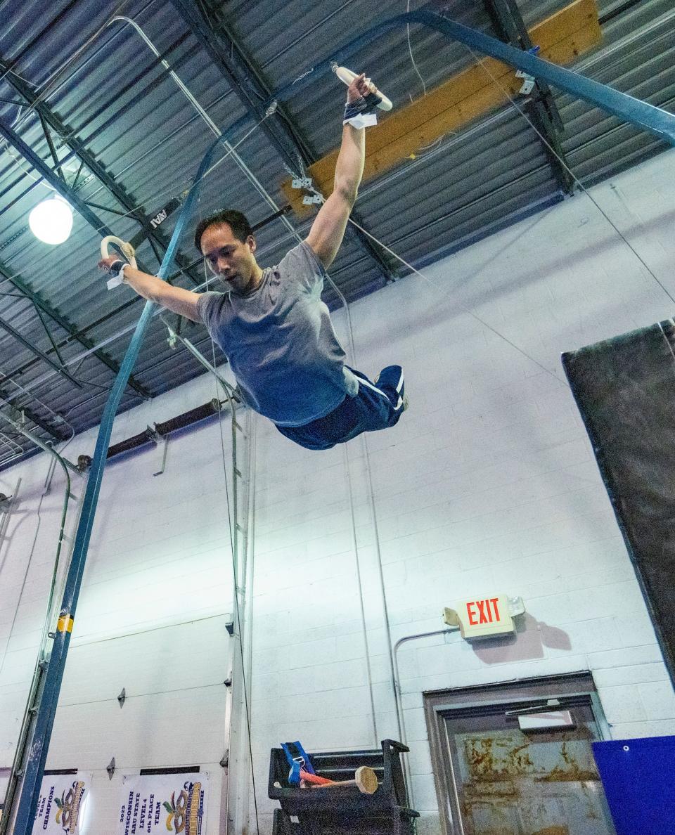 Ray Wu practices the rings at adult gymnastics class at Wildcard Gymnastics.