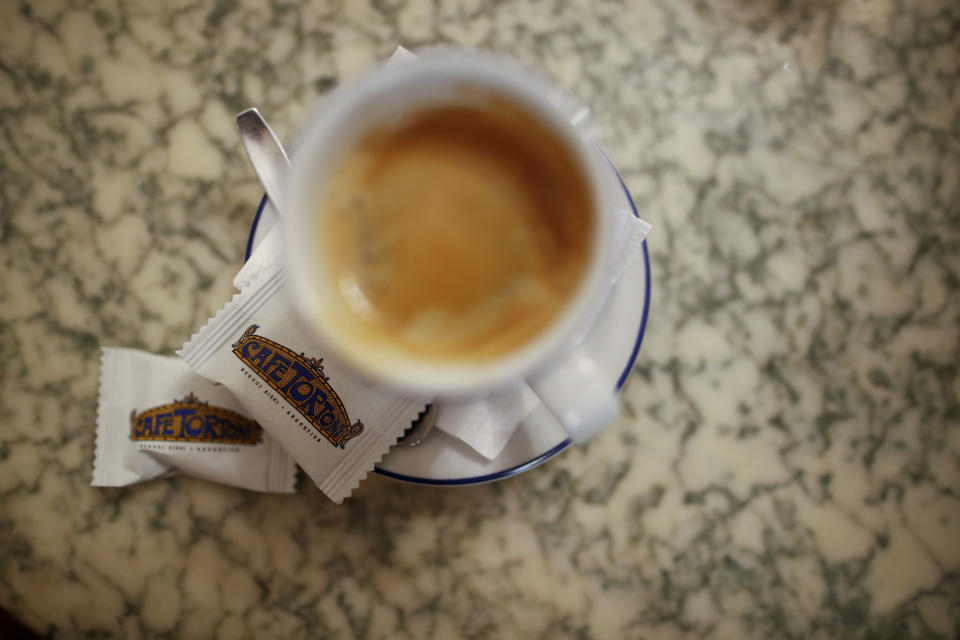 A coffee sits on a table at Cafe Tortoni in Buenos Aires, Argentina, Tuesday, Nov. 10, 2020. Buenos Aires has long had a thriving cafe scene but they are struggling to survive what their owners say is the worst crisis in their history caused by the new coronavirus pandemic lockdown measures, on top of a deep, years-long recession. (AP Photo/Natacha Pisarenko)