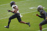 Louisville running back Javian Hawkins, left, dashes away from Pittsburgh defensive back Damar Hamlin, right, on his way to a long touchdown run during the first half of an NCAA college football game, Saturday, Sept. 26, 2020, in Pittsburgh. (AP Photo/Keith Srakocic)