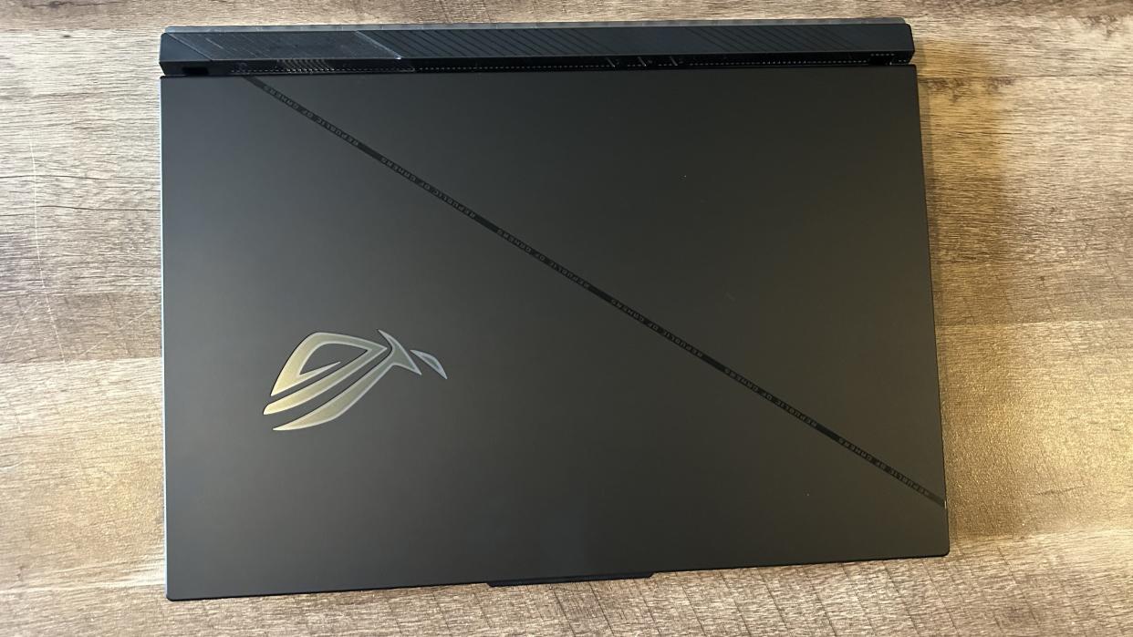  Asus ROG Strix Scar 18 lid closed on a wooden table. 