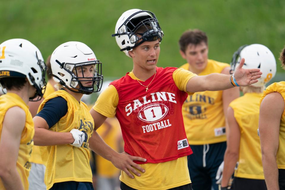 Saline football quarterback CJ Carr instructs teammates during practice at Saline High School on Monday, Aug. 7, 2023.