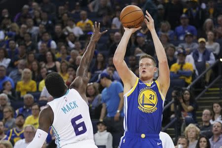 March 31, 2019; Oakland, CA, USA; Golden State Warriors forward Jonas Jerebko (21) shoots the basketball against Charlotte Hornets guard Shelvin Mack (6) during the third quarter at Oracle Arena. Mandatory Credit: Kyle Terada-USA TODAY Sports