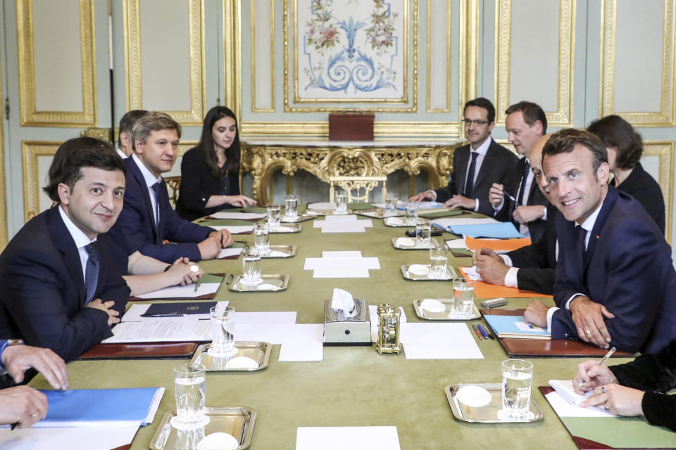 French President Emmanuel Macron, right, poses with Ukrainian President Volodymyr Zelenskiy, left, during a meeting at the Elysee Palace, in Paris, Monday, June 17, 2019. (Ludovic Marin/Pool via AP)