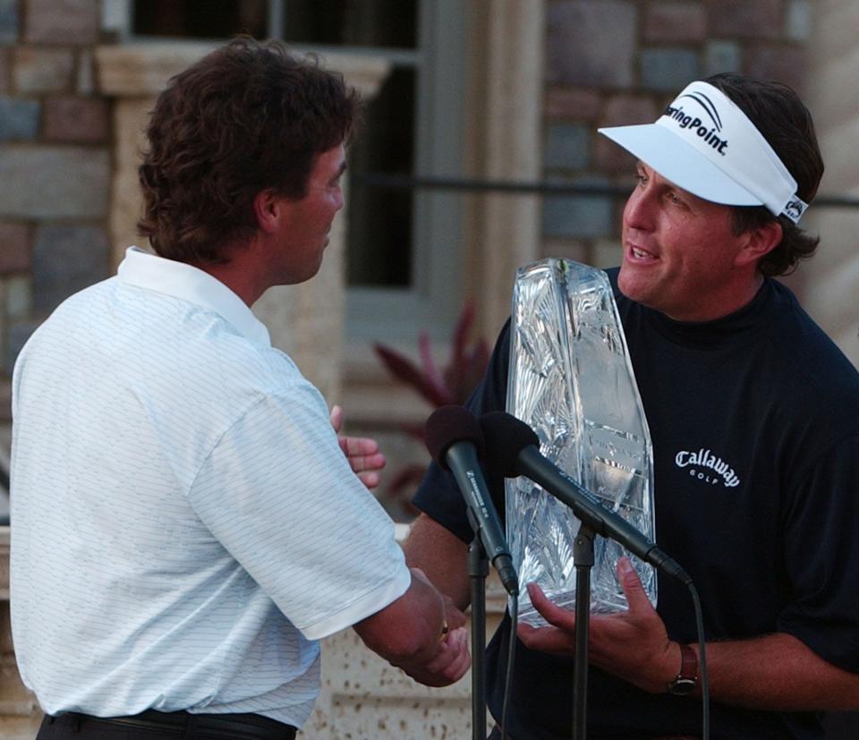 Phil Mickelson accepts the 2007 Players Championship trophy from the previous winner, Stephen Ames.