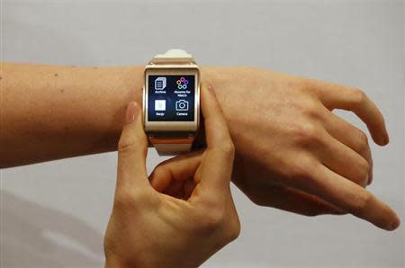 A model presents a Samsung Galaxy Gear smartwatch after its launch at the IFA consumer electronics fair in Berlin, September 4, 2013. REUTERS/Fabrizio Bensch