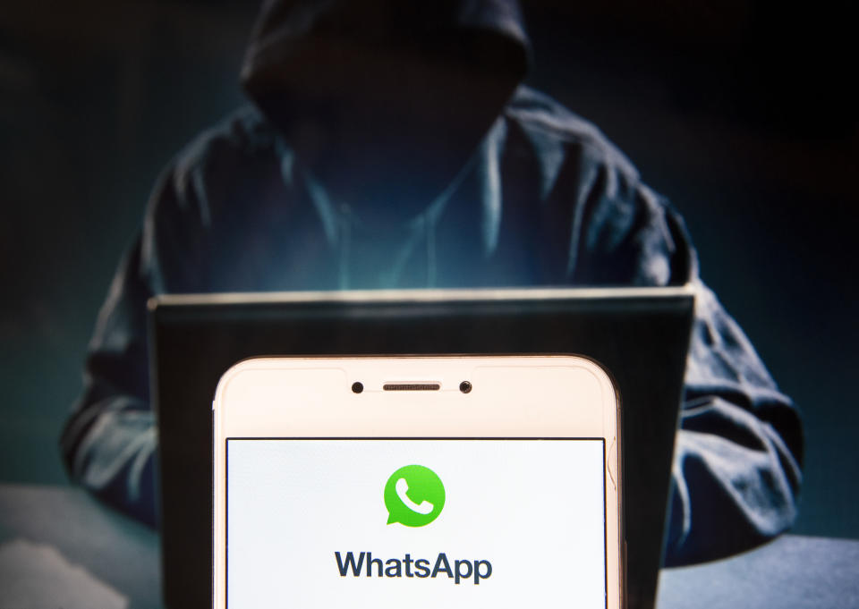 HONG KONG - 2018/11/22: Encrypted instant messaging application WhatsApp logo is seen on an Android mobile device with a figure of hacker in the background. (Photo by Miguel Candela/SOPA Images/LightRocket via Getty Images)