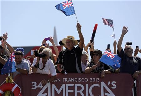 Fans of Emirates Team New Zealand cheer after their team defeated Oracle Team USA during Race 11 of the 34th America's Cup yacht sailing race in San Francisco, California September 18, 2013. REUTERS/Robert Galbraith