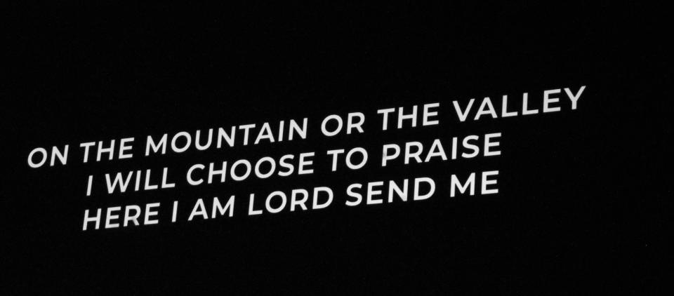 A message on a video board at Highland Church of Christ during ordination.
