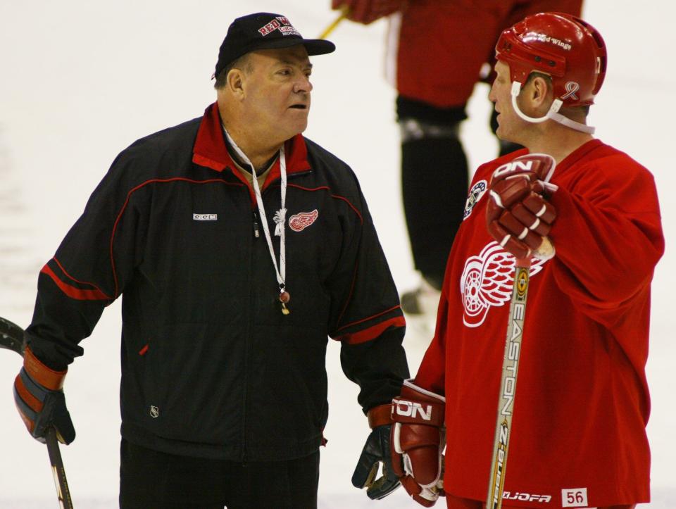 Detroit Red Wings head coach Scotty Bowman has a word with forward Brett Hull during practice in Denver, Friday, May 4, 2002.