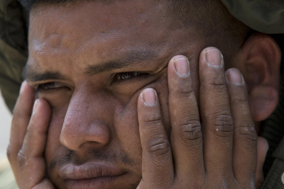 <p>A man, part of the the annual Stations of the Cross caravan march for migrants’ rights, sits silently during a protest at the Angel of Independence monument in Mexico City, Saturday, April 7, 2018. (Photo: Marco Ugarte/AP) </p>