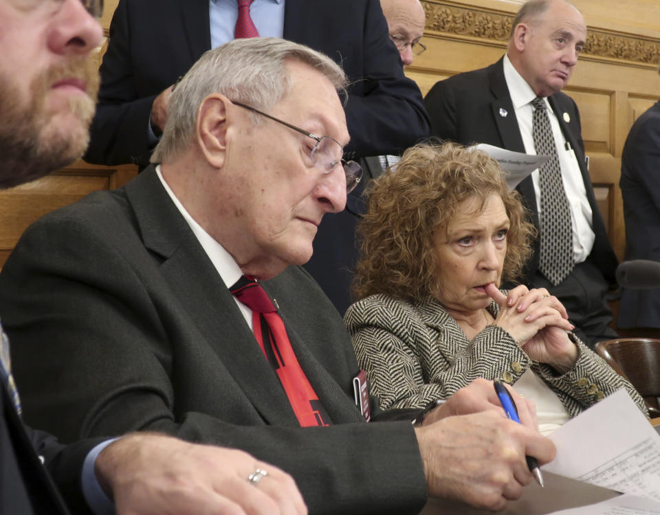 Kansas state Reps. Richard Proehl, left, R-Parsons, and Sydney Carlin, D-Manhattan, follow a briefing on Gov. Laura Kelly's budget proposals, Thursday, Jan. 17, 2019, at the Statehouse in Topeka, Kan. Kelly outlined an $18.4 billion spending blueprint for the budget year beginning in July. (AP Photo/John Hanna)