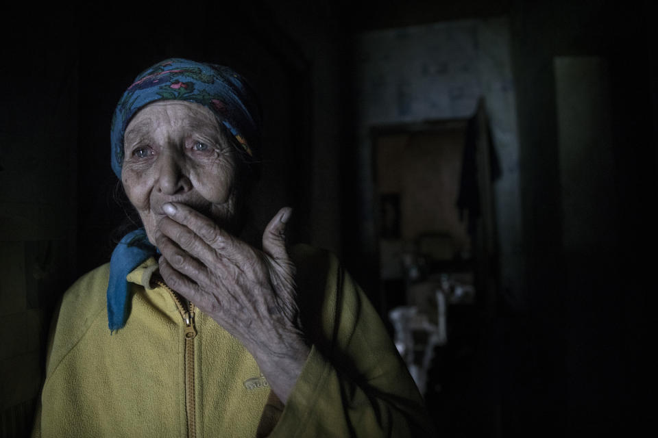 <span class="s1">Mariya Gorpynych, age 76, lives alone in the village of Opytne. She speaks with tears in her eyes about the death of her son, Victor, who died at age 48 when their home was hit by shelling in 2016. He died in her arms. Her husband died in the same year from a heart attack caused by the stress of living too close to the frontline. Mariya refuses to leave: <i>“I have nowhere to flee, my whole family is buried here. I got used to the continued shelling.” </i>Opytne is on the contact line, and only 43 people are left. (Photograph by Paula Bronstein)</span>