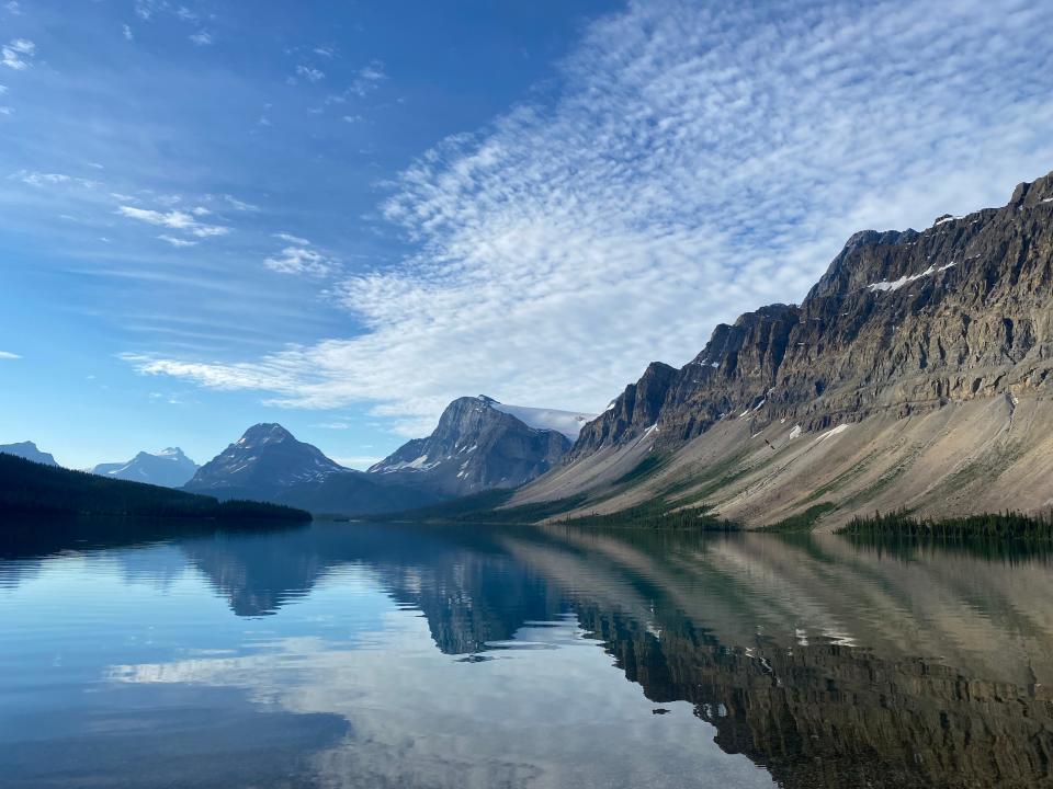 Crowfoot Mountain rises majestically as its austere beauty reflects on the surface of Bow Lake. This pristine wilderness is located north of Lake Louise, Alberta.