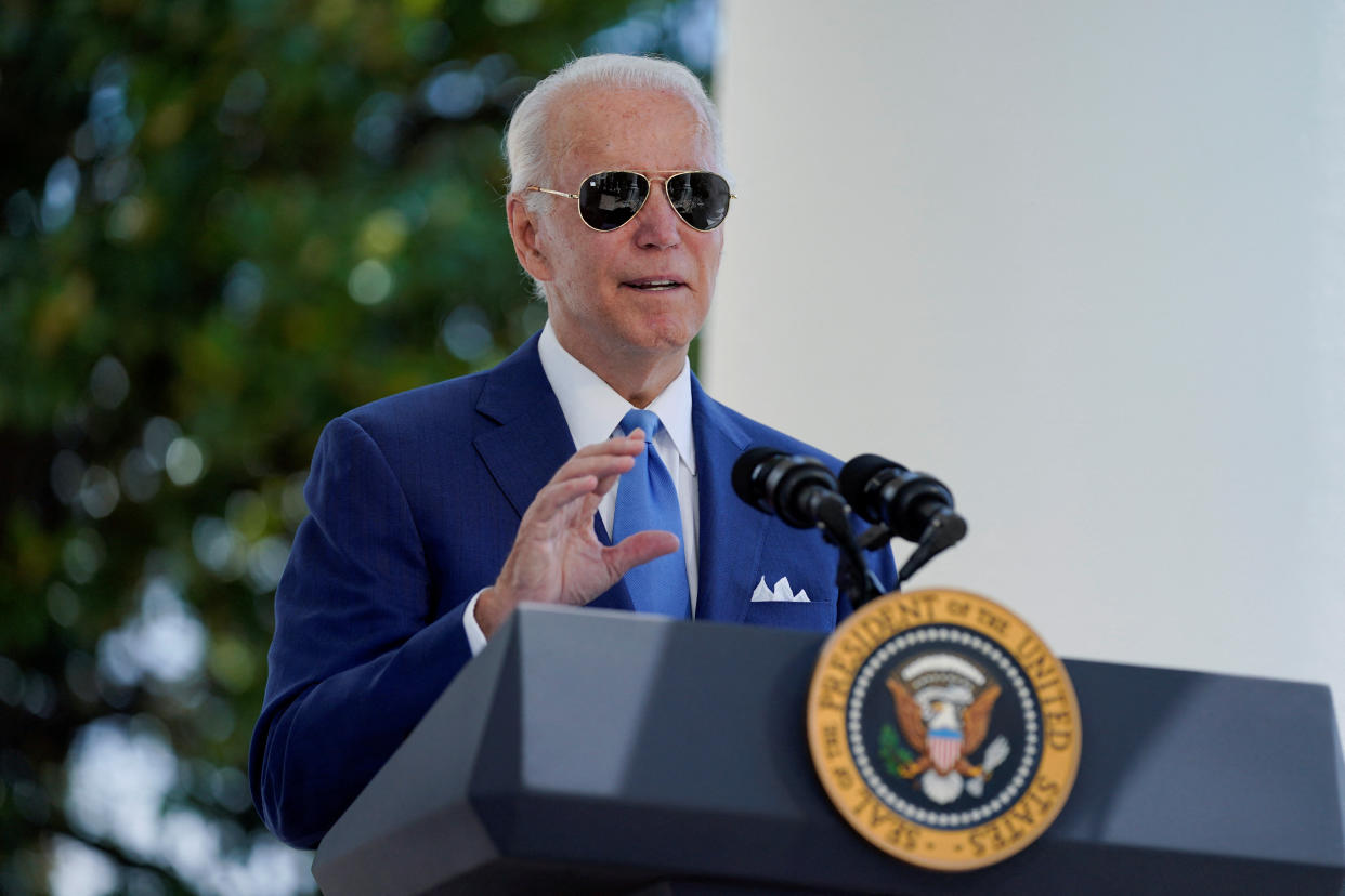 President Biden speaks at a podium outside the White House.