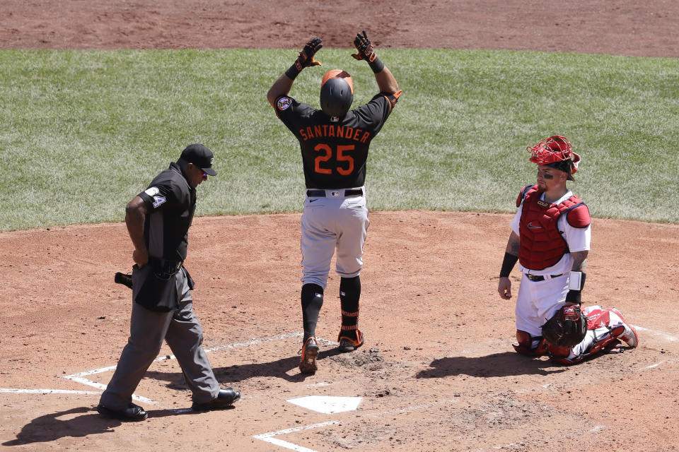 Baltimore Orioles' Anthony Santander, center, celebrates a two-run home run as he arrives at home plates while Boston Red Sox's Christian Vazquez, right, looks on during the fourth inning of a baseball game Sunday, July 26, 2020, in Boston. (AP Photo/Steven Senne)