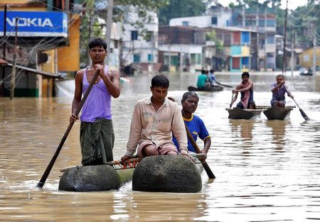 People paddle their boats as they try to move to safer places along a flooded street in West Midnapore district, in West Bengal. REUTERS/Rupak De Chowdhuri