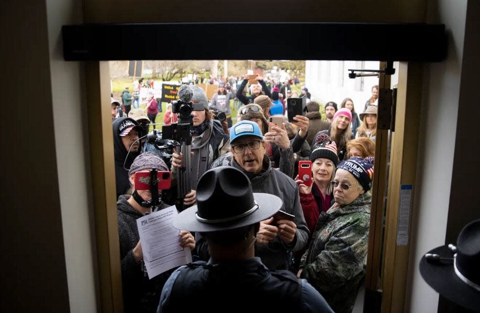 Photographer Brian Hayes took first place for best news photo in the Oregon Newspaper Publishers Association's 2023 contest for this image of protesters opposing COVID-19 vaccine and mask mandates being refused entry into the Oregon State Capitol building without a mask on Feb. 1, 2022.