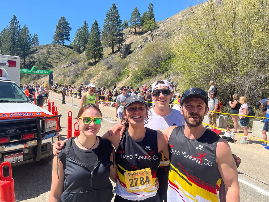 The winner of the 2024 Race to Robie Creek, Nathaniel Souther, center, poses with friends after the half marathon.