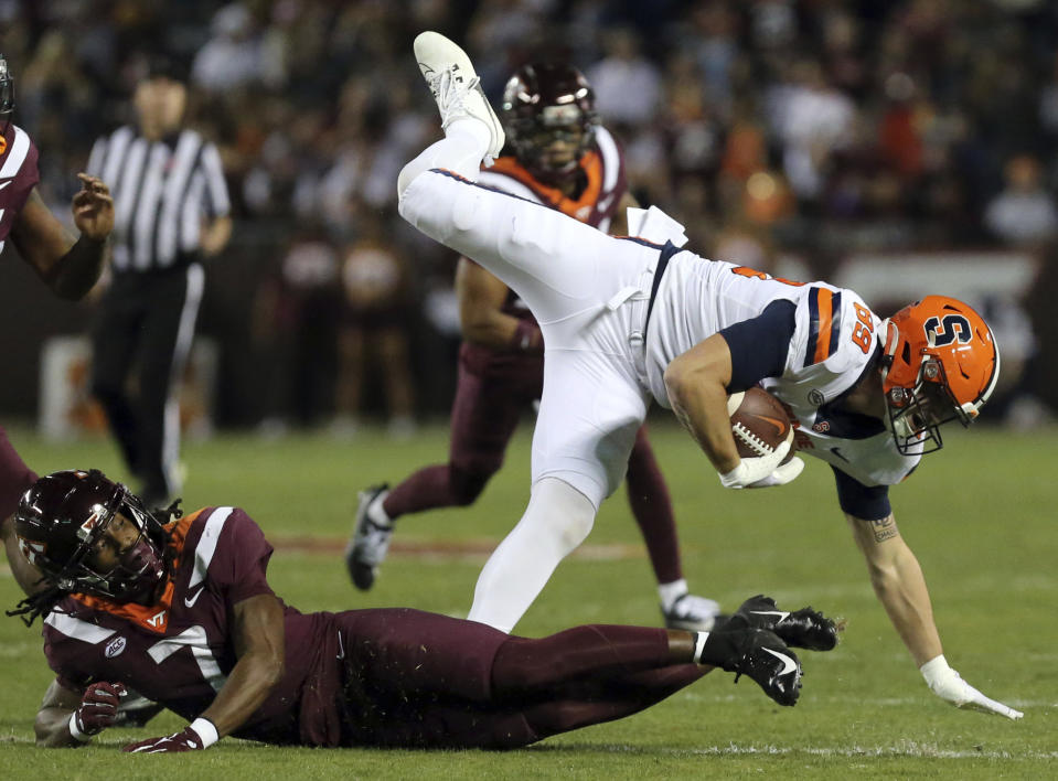 Syracuse's Dan Villari (89) is upended by Virginia Tech linebacker Keonta Jenkins LB (7) during the first half of an NCAA college football game in Blacksburg, Va., Thursday, Oct. 26, 2023. (Matt Gentry/The Roanoke Times via AP)